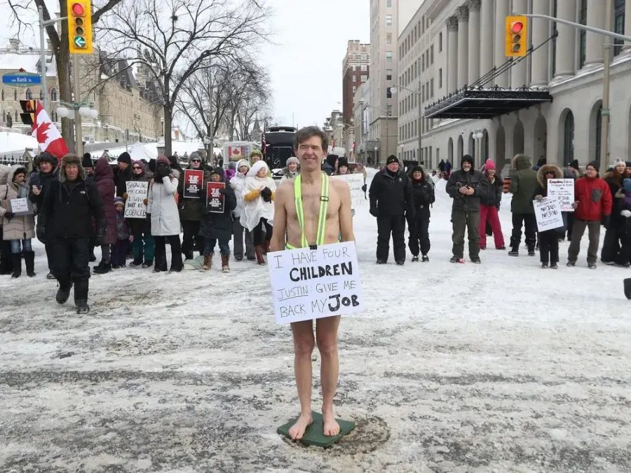 Anti-vaccine mandate protesters and truckers protesting their eighth day in Ottawa Friday. Liam, who is wearing a billboard was out protesting on Wellington Street asking for support to have the choice with his own body.