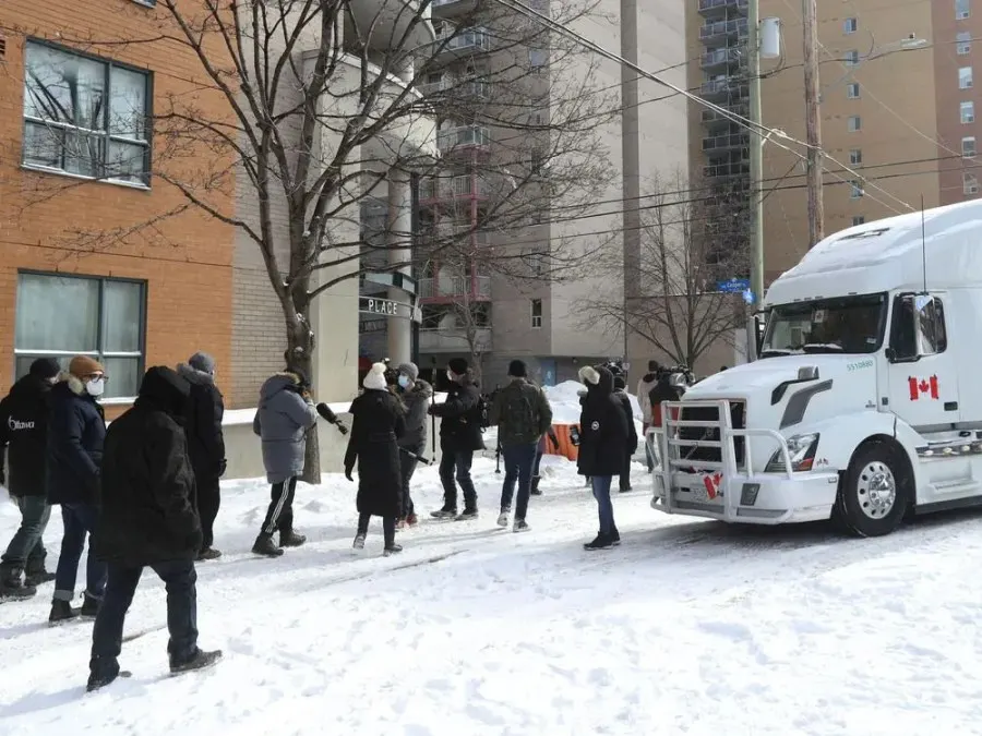 A few members of Ottawa city council, some community members and a lot of media walk down Kent Street in Ottawa Friday. The councillors wanted to get out in the community and let residence know they are there to support them.