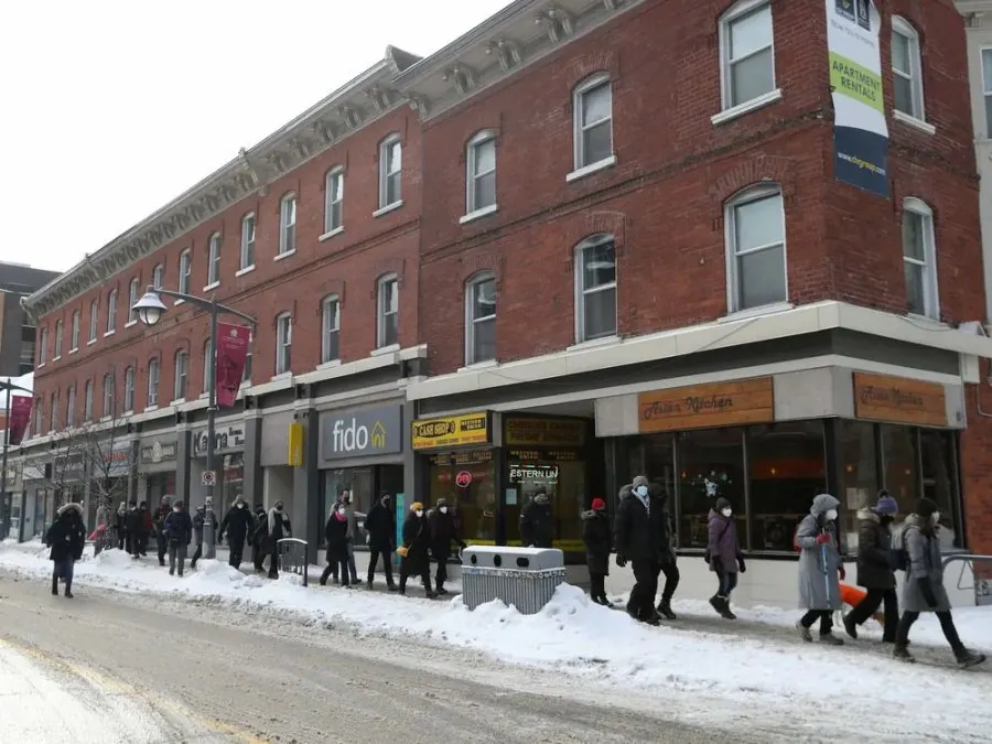 A few members of Ottawa city council, some community members and a lot of media walk down Bank Street in Ottawa Friday. The councillors wanted to get out in the community and let residence know they are there to support them.