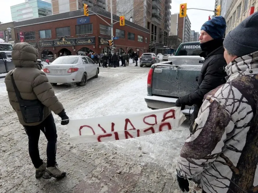 A few members of Ottawa city council, some community members and a lot of media walk down Bank Street in Ottawa Friday. The councillors wanted to get out in the community and let residence know they are there to support them.