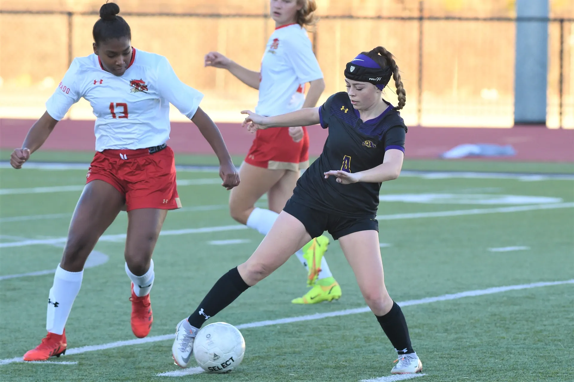 Wylie's Britt Downs (4) pulls the ball away from a defender during Monday's District 4-5A opener against Lubbock Coronado.