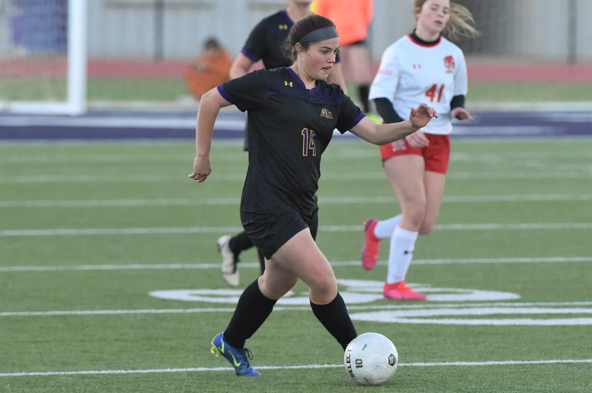 Wylie's Maci Hanson (14) runs in the ball during Monday's District 4-5A opener against Lubbock Coronado.