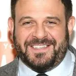 The Useful Kitchen Item Adam Richman Brings On His Travels